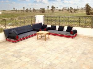 a couch sitting on a patio with a table at Spacious villa with private pool in Djerba in Houmt Souk +61 photos