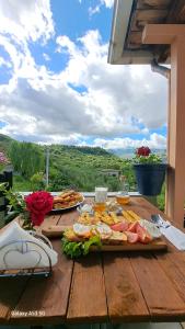 a wooden table with food on top of it at Bujtina ANLU in Gjirokastër