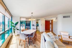 a dining room and living room with a table and chairs at The Landmark #2705 in Honolulu