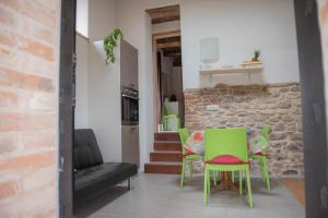 a living room with green chairs and a couch at La casa del Colle in San Ginesio