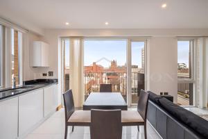 a kitchen and dining room with a view of the city at Still Life Euston Deluxe in London