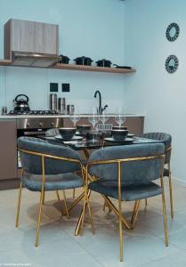 a kitchen with a table and chairs with wine glasses at Casa de Amor - Stylish Apartment in Rosebank in Johannesburg