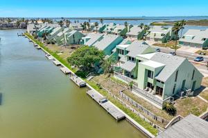 an aerial view of a row of houses next to the water at Aloha Condo in Padre Island