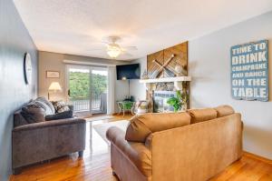 a living room with two couches and a ceiling fan at Cozy Lake Ozark Condo Rental with Grill, Pool Access in Lake Ozark