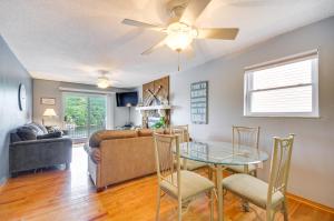 a living room with a table and a couch at Cozy Lake Ozark Condo Rental with Grill, Pool Access in Lake Ozark