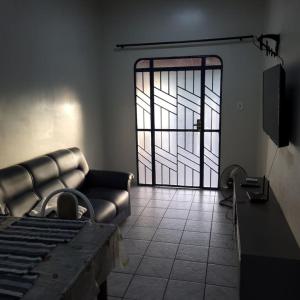 a living room with a couch and a glass door at Apartamento em Jardim Floresta in Boa Vista