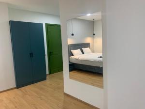 a bedroom with a mirror and a bed in it at Hotel City Lights - Tbilisi in Tbilisi City