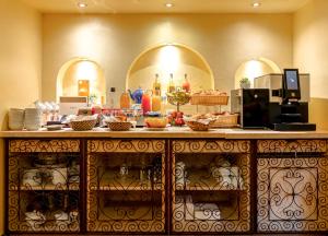 a kitchen with a counter with food on it at Villa Royale Montsouris in Paris