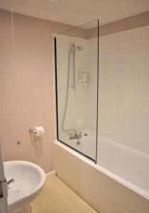 a bathroom with a shower and a sink at Cawley Priory - Family Friendly, City Centre Apartment, Sleeps 4 in Chichester