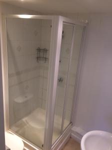 a shower with a glass door in a bathroom at Chichester Quarters - Ground Floor, City Centre, 2 Bedroom Apartment in Chichester