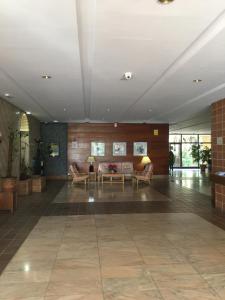 a large room with a lobby with couches and tables at golf y playa in Benalmádena +16 photos