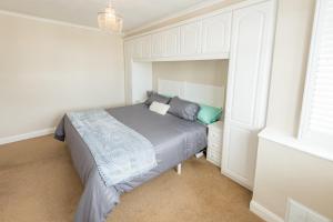 a small bedroom with a bed and a window at Cosy Family Home in Ruislip in Ruislip
