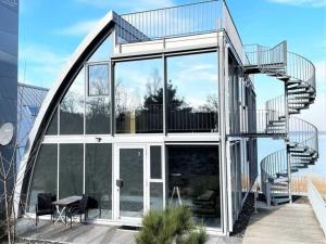 a glass house with a spiral staircase in the middle at Appartment Düne 6 1OG Grundbelegung 2 Pers in Elsterheide