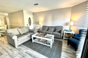 a living room with a couch and a table at Gulfside Townhome 13 Townhouse in Gulf Shores
