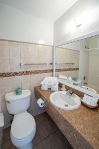 łazienka z toaletą, umywalką i lustrem w obiekcie Ocean Surf Resort w mieście Montauk