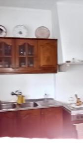 a kitchen with wooden cabinets and a sink at 3 bedrooms apartement with city view and wifi at Amora 8 km away from the beach in Amora