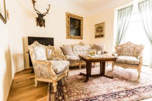 a living room with two chairs and a table at Villa Thalhof in Bad Gleichenberg