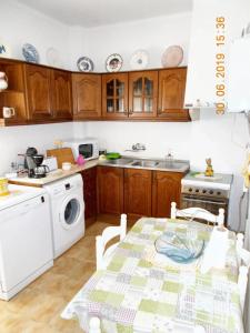 a kitchen with a table and a washing machine at 3 bedrooms apartement with city view and wifi at Amora 8 km away from the beach in Amora