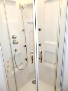 a shower with a glass door in a bathroom at 3 bedrooms apartement with city view and wifi at Amora 8 km away from the beach in Amora