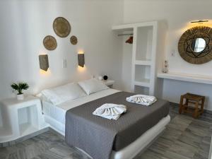 una camera da letto con un letto e due asciugamani di Magginas Studios a Paroikia