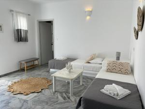 a living room with two beds and a couch at Magginas Studios in Parikia +88 photos