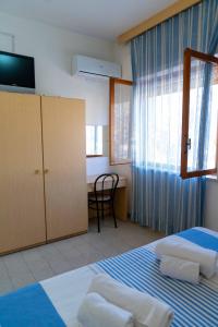 Postel nebo postele na pokoji v ubytování Hotel dei Focesi