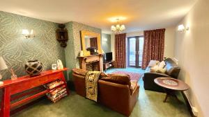 a living room with a couch and a chair at Beautiful Mumbles/Gower cottage in Swansea
