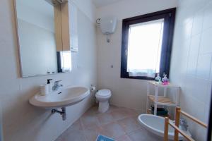 a white bathroom with a sink and a toilet at Casa Martina in Pula +55 photos