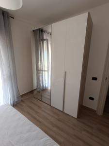 1 dormitorio con espejo grande y cama en Casa Calatia, en Maddaloni