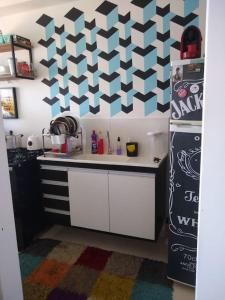 a kitchen with a refrigerator and a white counter top at O melhor apt 1 quarto da Serra -ES in Serra