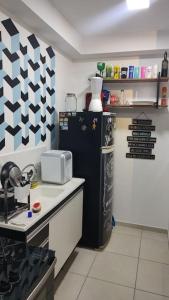 a kitchen with a black refrigerator and a counter at O melhor apt 1 quarto da Serra -ES in Serra