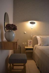 a bedroom with a bed and a table with a mirror at Amarillo Apt. Nafplio Downtown in Nafplio