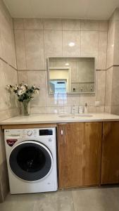 a kitchen with a washing machine and a sink at Promenaadi Apartment in Võru