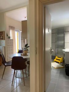 a kitchen and dining room with a table and chairs at Amarillo Apt. Nafplio Downtown in Nafplio
