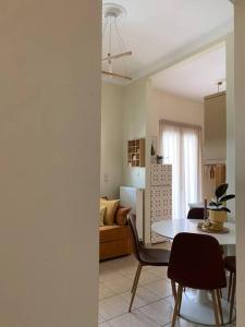 a kitchen and living room with a table and chairs at Amarillo Apt. Nafplio Downtown in Nafplio
