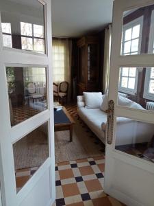 a living room with a white couch and a table at Maison familiale Cabourg in Cabourg