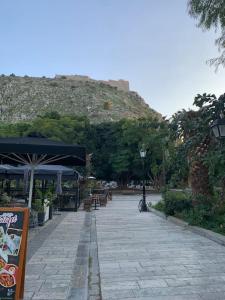 a stone walk way with a mountain in the background at Amarillo Apt. Nafplio Downtown in Nafplio