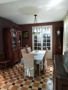a dining room with a table and chairs at Maison familiale Cabourg in Cabourg