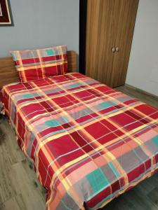 a bed with a colorful blanket on it in a room at CASCINA PONTETTO in Asti