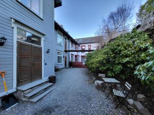 a walkway between two buildings with benches next to a house at Sunset Penthouse, Fjord View & Parking in Trondheim
