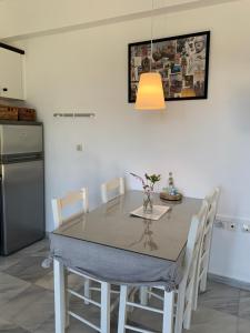 a kitchen with a dining room table with chairs at Villa Aliki in Myrtos