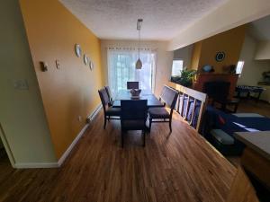 a dining room and living room with a table and chairs at Cozy and quiet place to relax and unwind . in Tannersville