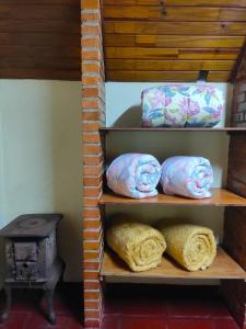 a shelf with pillows and a stove in a room at Pedra Grande Adventure Park in Atibaia