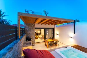 a villa with a swimming pool at night at Atria luxury experience in Kattavía