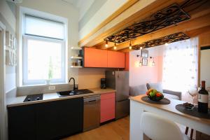 a kitchen with a sink and a refrigerator and a table at STUDIO MO in Opatija