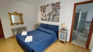 a bedroom with a blue bed and a mirror at Hotel Da Bruno in Rocchetta Ligure