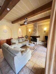 a living room with a couch and a fireplace at Sant Antnin B&B in Munxar