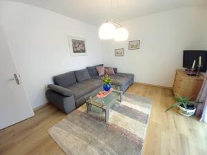 a living room with a couch and a table at Ferienwohnung Steuerberg in Feldkirchen in Kärnten