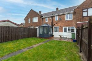 a garden with a gazebo in front of a house at Park Green in Stockton-on-Tees