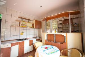 a kitchen with a table and chairs in it at CASA PHOENIX in Eforie Nord